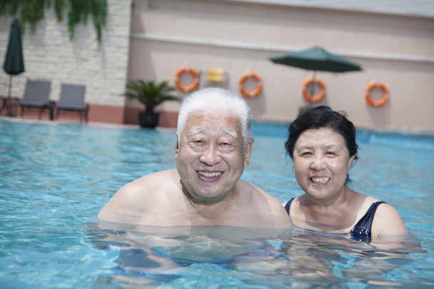 Senior couple relaxing in the pool - Photo, Image