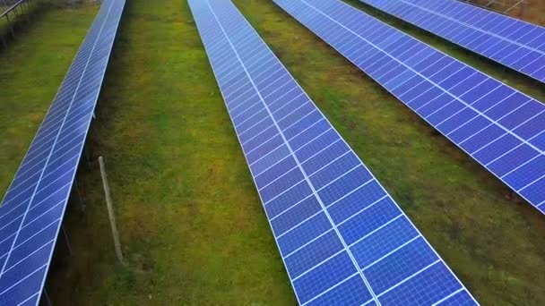 Solar power plant in summer. Innovative solar batteries on the field. Production of clean energy. Aerial view. - Materiaali, video