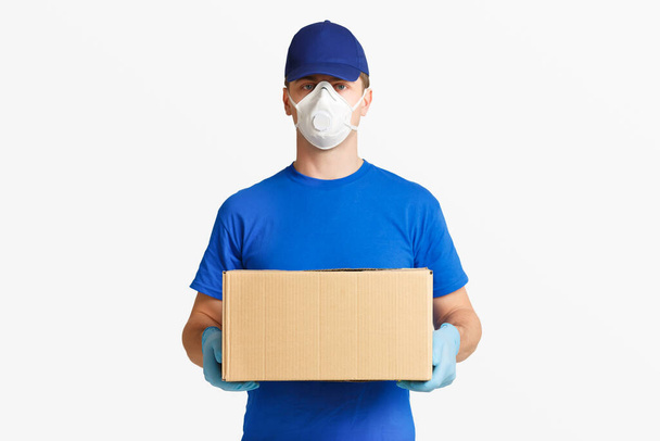 Fast delivery parcels. Courier in blue uniform - Фото, изображение