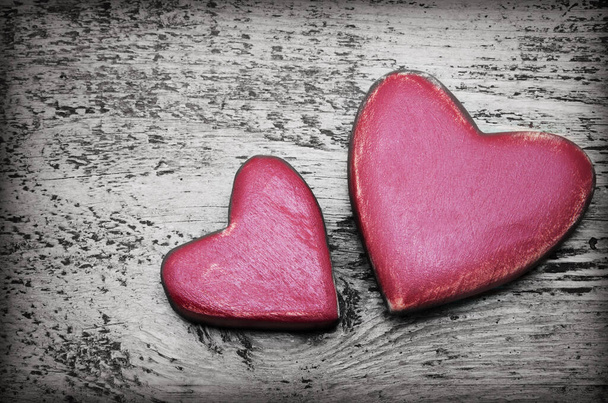 Zwei rote Herzen auf altem schäbigen Holzgrund - Foto, Bild
