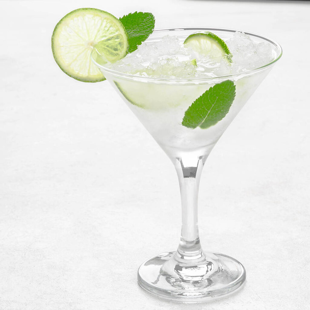 Mojito in a martini glass on a light background stands on the table - Foto, Bild