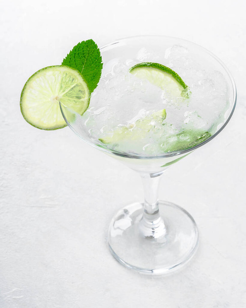 Mojito in a martini glass on a light background stands on the table - Fotografie, Obrázek