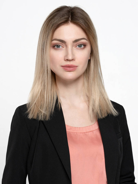 Blonde girl in a black jacket on a white background - Foto, immagini