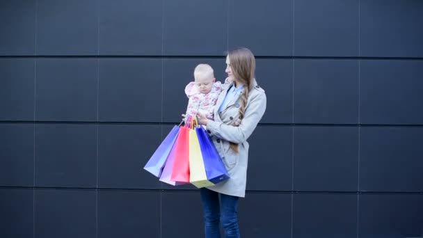 Mother with little daughter on hands are shopping at outlet store. - Footage, Video