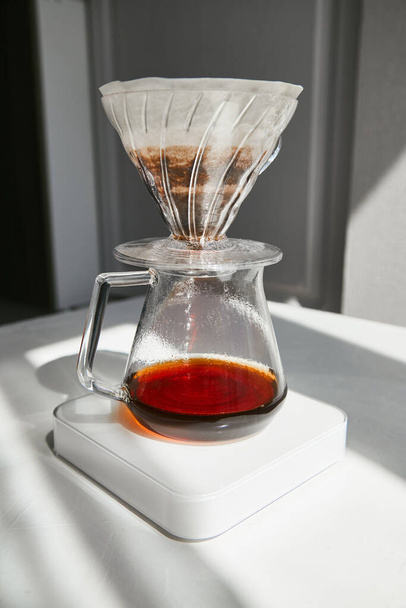Brew coffee using a drip method. Pour-over natural coffee hot water through the filter . - Foto, immagini