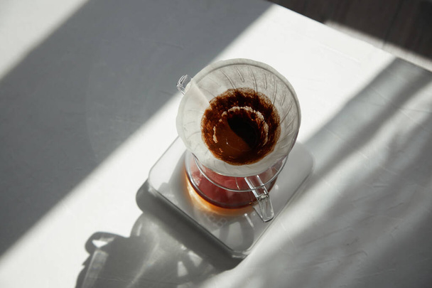 Brew coffee using a alternative method. Pour-over ground natural coffee hot water through the filter . - Photo, Image