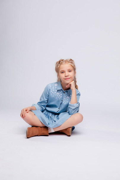 long-haired girl sitting cross-legged - Valokuva, kuva