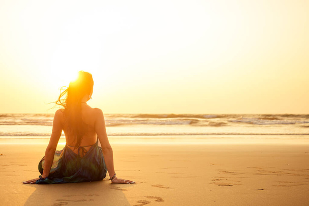Outdoor young pretty woman posing near the sea alone - Фото, изображение