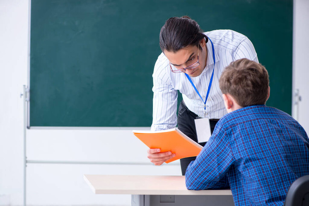 Young male teacher and boy in the classroom - Foto, Bild