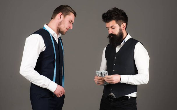 Man with beard pay to macho with measuring tape. - Photo, image
