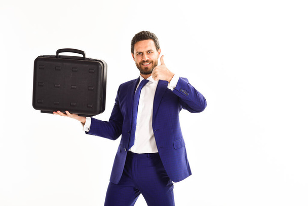 Man carries black case in hand. Man in suit - Foto, afbeelding