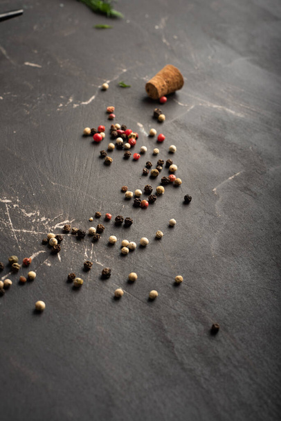 Scattered peppercorns on a kitchen table - Fotó, kép