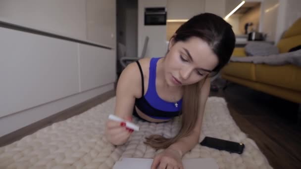 Sportive woman make a notes at home - Materiaali, video