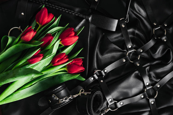 Various sex toys set black background. The view from the top. Tulips. Valentines day - Фото, зображення