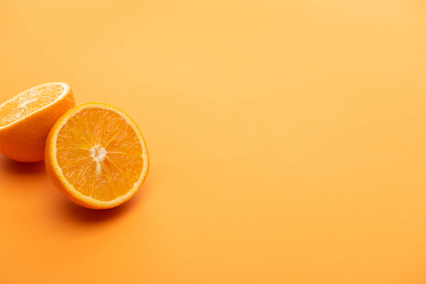 ripe delicious orange halves on colorful background - Photo, Image