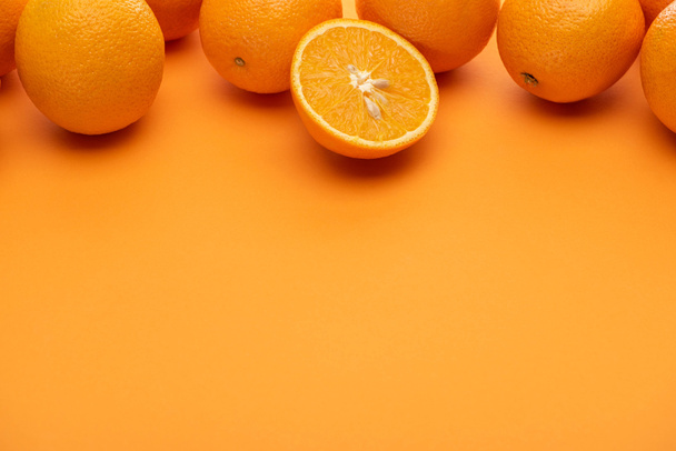ripe juicy whole and cut oranges on colorful background - Photo, Image