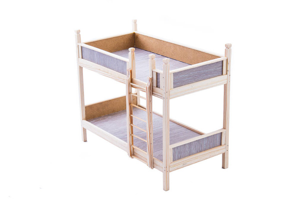 Іграшка дерев'яна двоярусна ліжко для ляльки ізольована на білому тлі
 - Фото, зображення
