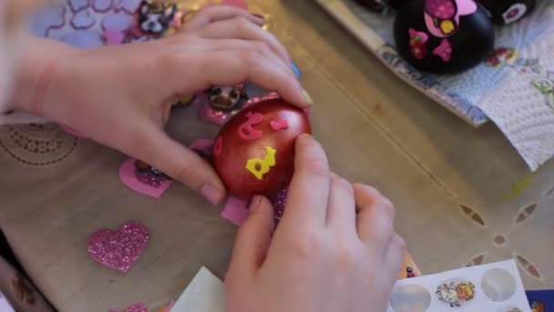 eight year old girl paints chicken eggs nor Easter holiday - Footage, Video