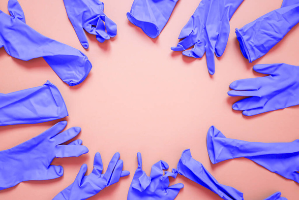 rubber gloves placed as a frame on pink background - Photo, Image