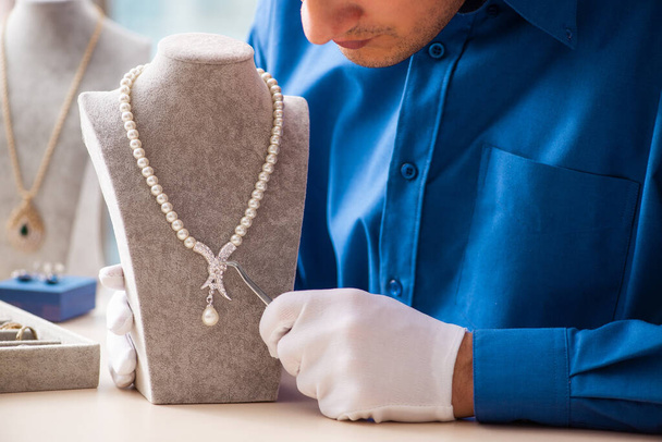 Young jeweler working in his workshop - Photo, image