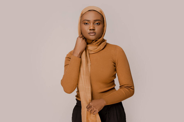 Muslim woman beautiful African ethnicity wearing traditional hijab, traditional eastern Arabic islam religion clothes. Over white studio background. People and religion. Confident smart muslim woman - Valokuva, kuva