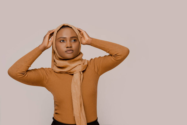 Muslim woman beautiful African ethnicity wearing traditional hijab, traditional eastern Arabic islam religion clothes. Over white studio background. People and religion. Confident smart muslim woman - Photo, Image