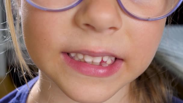 Little child girl smiles and shows first wobby tooth - Footage, Video