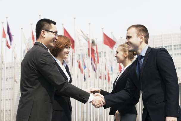 Business people meeting and shaking hands outdoors - Photo, Image