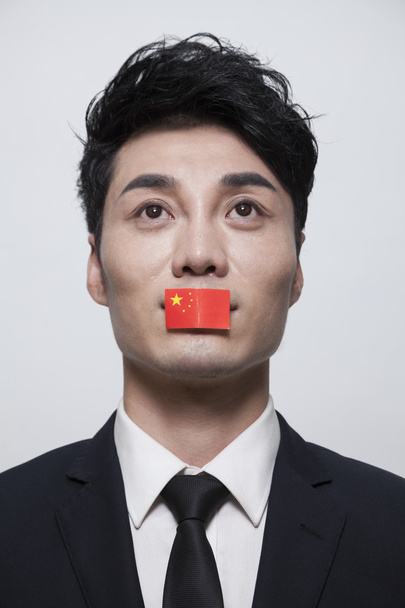 üzletember egy kínai zászló, amely a száját - Fotó, kép