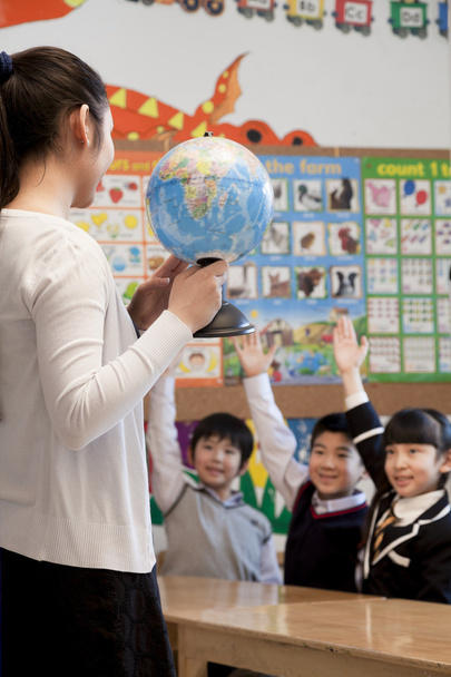 Вчитель викладання географії школярам з глобусом
 - Фото, зображення