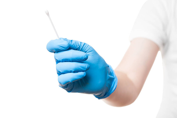 doctor hand in a blue sterile glove holds to give cotton swab for sampling smear analysis from the oral cavity for a virus test, mock up medical theme isolated on white background with copy space. - Photo, image