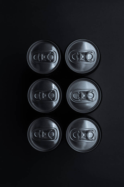 Set of aluminum cans on dark background, top view. - Фото, изображение