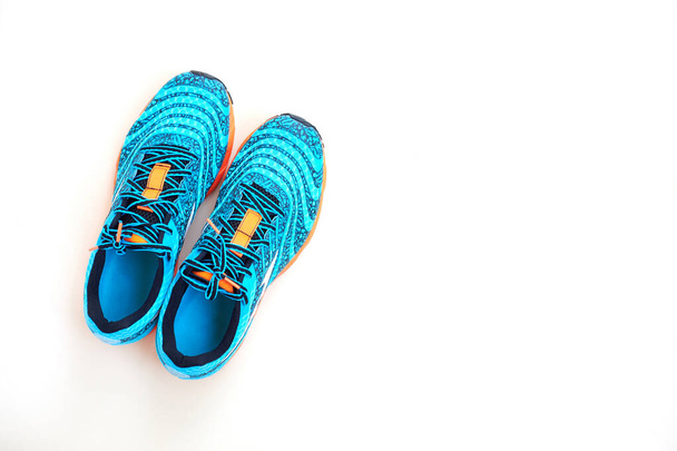 Concept run. Concept love run. Pair of bllue stylish running shoes on a white background. Top view. - Photo, Image