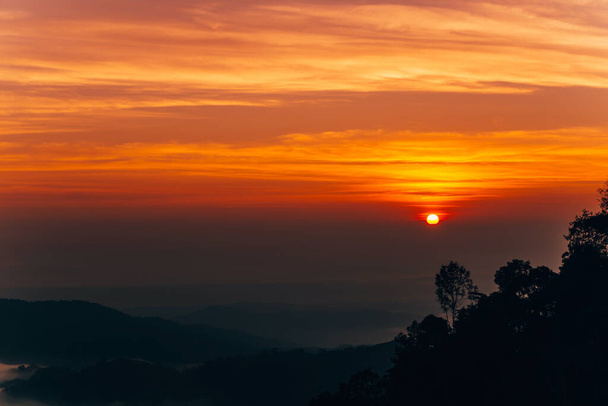 Mountain Mist in sunrise,mist on sunrise,mist over mountain during sunrise.Beautiful landscape in the mountains at sunrise. - Foto, imagen