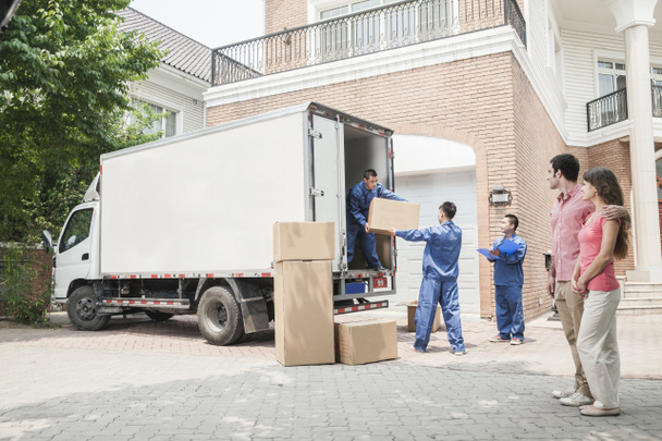 Casal assistindo móveis mover caixas da van em movimento
 - Foto, Imagem
