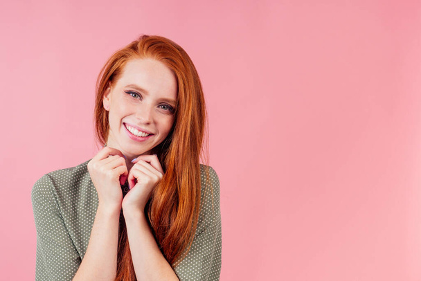 happy redhair ginger woman in studio background feeling heart thanks - Фото, изображение