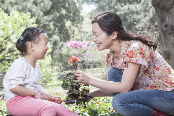 Mother and daughter planting flowers - Photo, Image