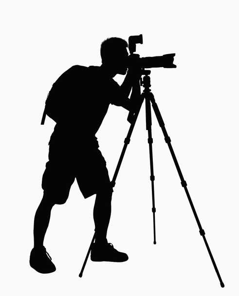 Silhouette of man taking pictures with camera - Foto, afbeelding