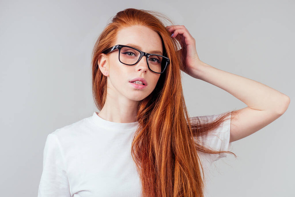 redhaired ginger woman wear glasses in white studio - Foto, Bild