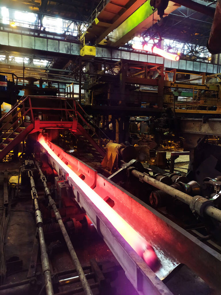 Endurecimiento de acero a alta temperatura en un horno industrial en un taller de molino de tubería. industria metalúrgica, producción de acero, laminador en caliente
 - Foto, Imagen