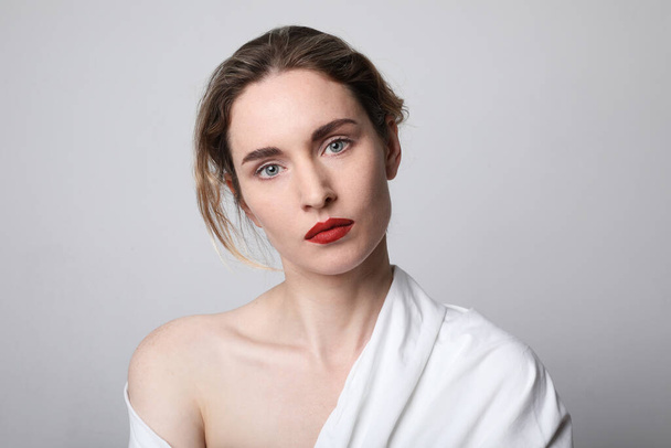 Beauty portrait of young woman with red lips wearing white clothing. Close-up portrait. Space for text. - Фото, зображення