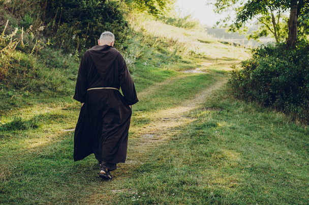 08.08.2019 Santiago de Compostela, Spain: a monk in robes praying in the woods. Copy space - Foto, immagini