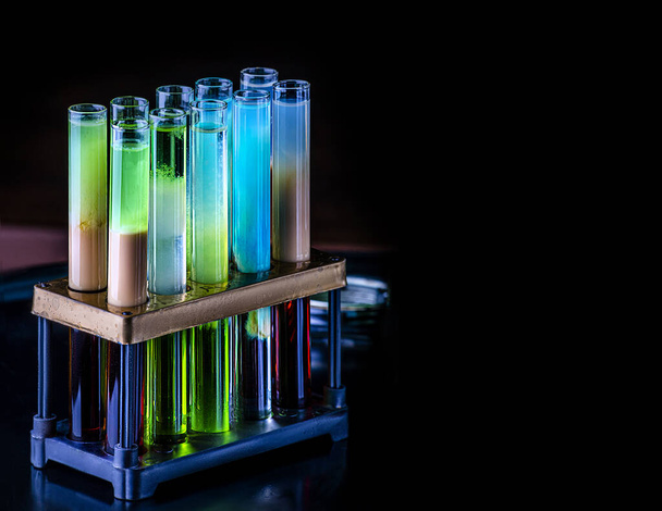 Cocktails in test tubes - creative alcohol bar drinks. Raibow liqhuids in tubes - Photo, Image