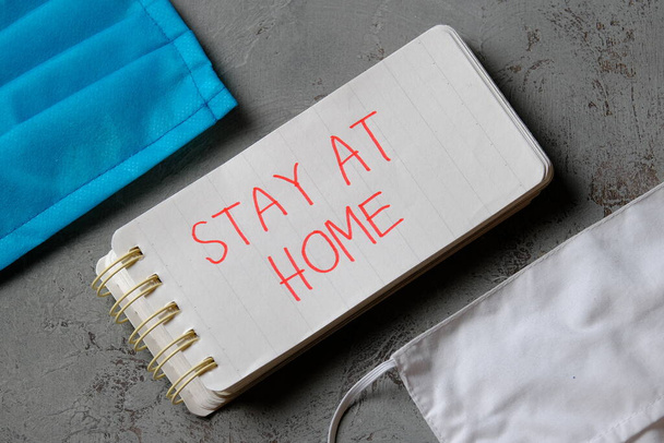 stay at home quote on small note book. The concept of health care and medical amid a corona virus pandemic - Φωτογραφία, εικόνα
