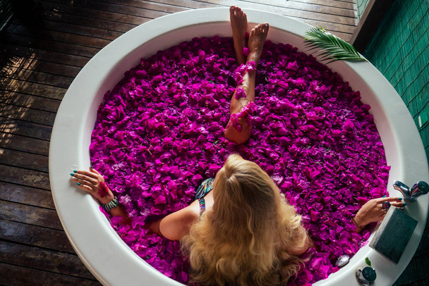 woman getting tropical bath in paradise spa resort - 写真・画像