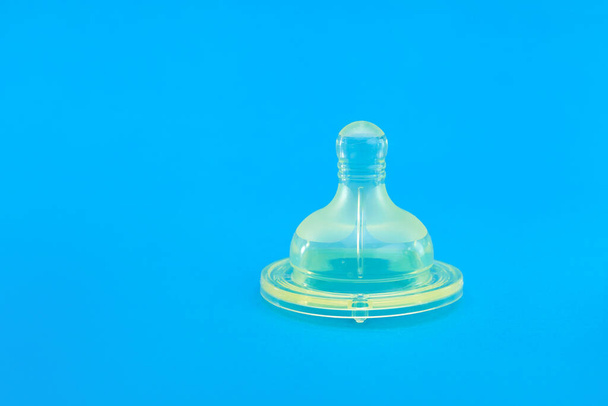 silicone pacifier for baby feeding bottle, health care object isolated on blue background with copy space, nobody. - 写真・画像