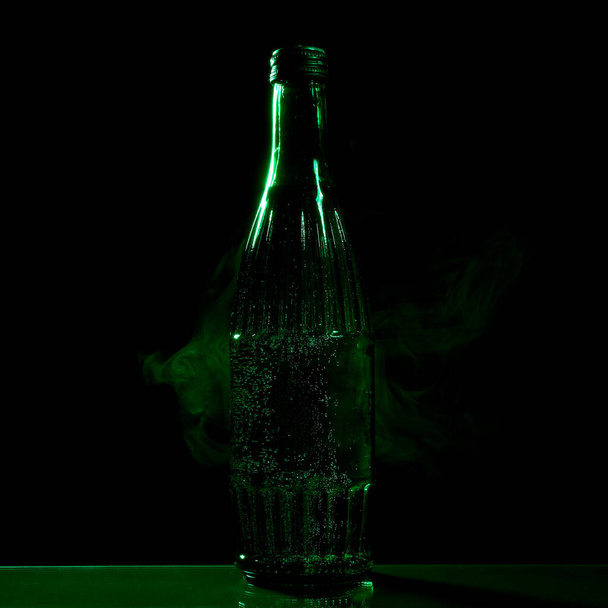 green bottle with mineral water on a black background - Photo, Image