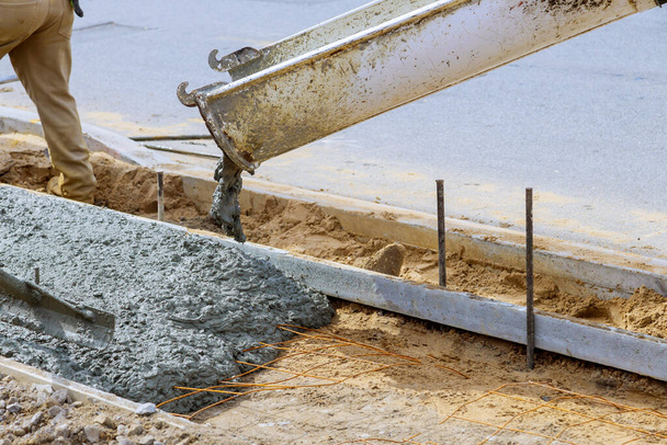 Industriële arbeiders gieten vers beton op gewapend cement trottoir - Foto, afbeelding