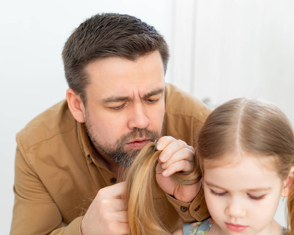 dad cuts hair at home child during quarantine. - Photo, Image