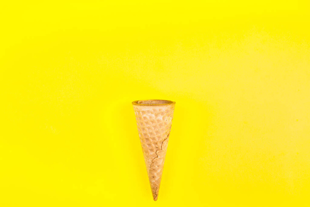 Cone of ice cream isolated on yellow background. - Photo, Image